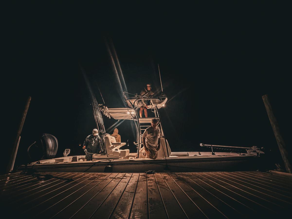 Fishing boat under lights at night